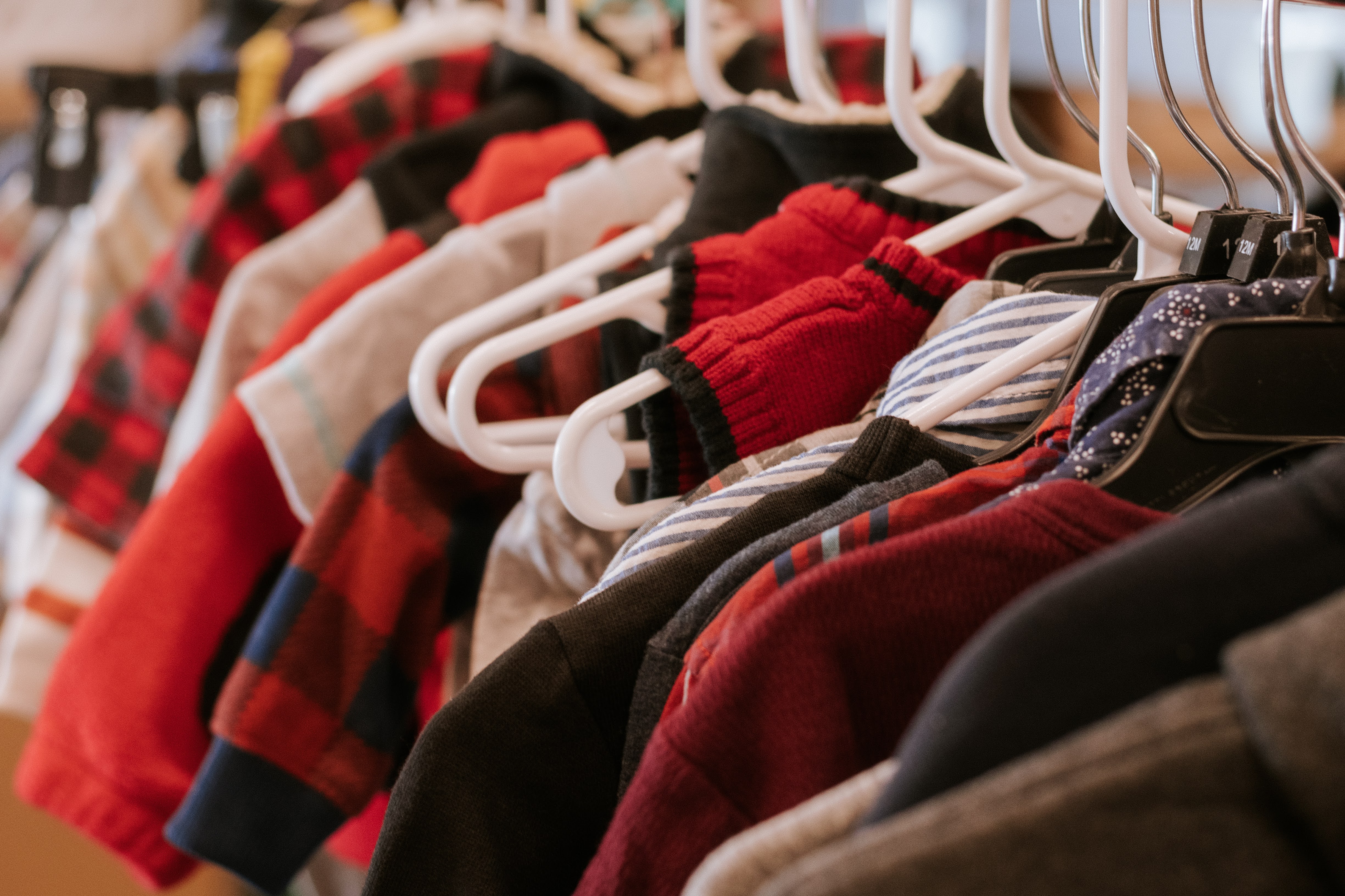 The Foster Alliance clothing on hangers
